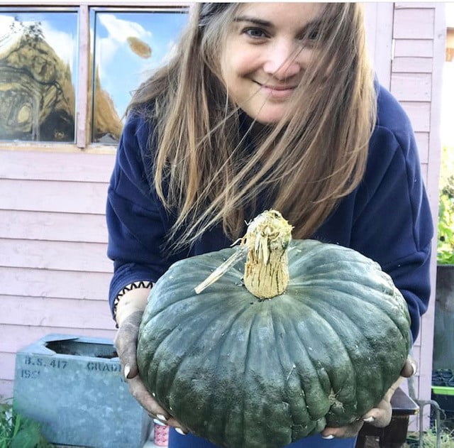 Kate and a pumpkin grow in her own allotment.