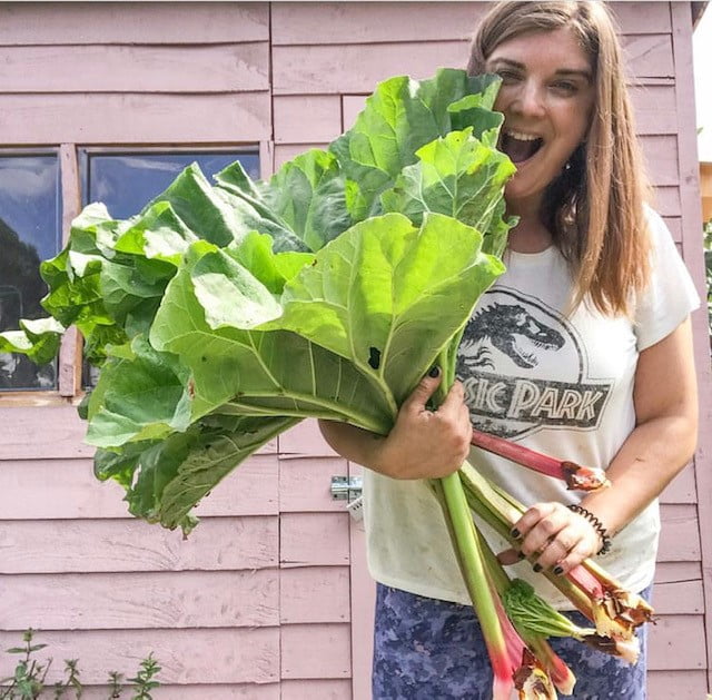 Kate from pumpkins_etc smiling and showing a rhubarb crop.